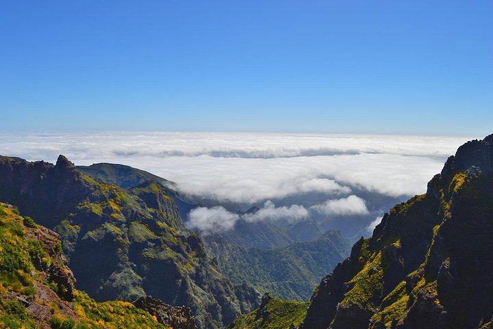Madeira levada walk — hikers along irrigation channel trail