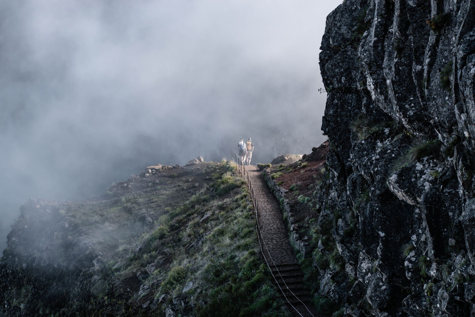 Hikers on a misty mountain trail in Madeira